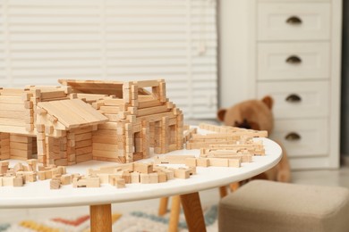 Photo of Wooden construction set on white table indoors, space for text. Children's toy