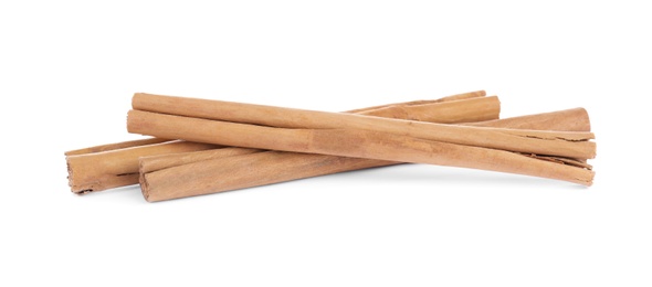 Photo of Aromatic brown cinnamon sticks on white background