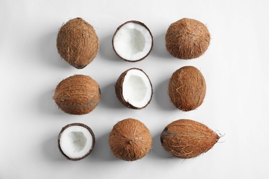 Photo of Ripe coconuts on white background, flat lay