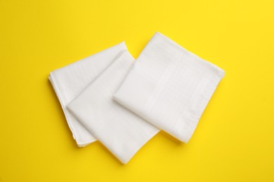 Photo of Stylish handkerchiefs on yellow background, flat lay