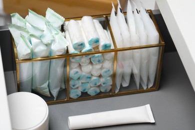 Photo of Storage of different feminine and personal care products in drawer, closeup