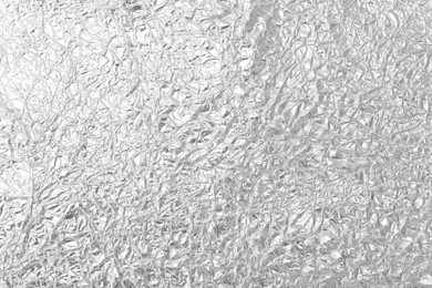 Photo of Crumpled silver foil as background, top view