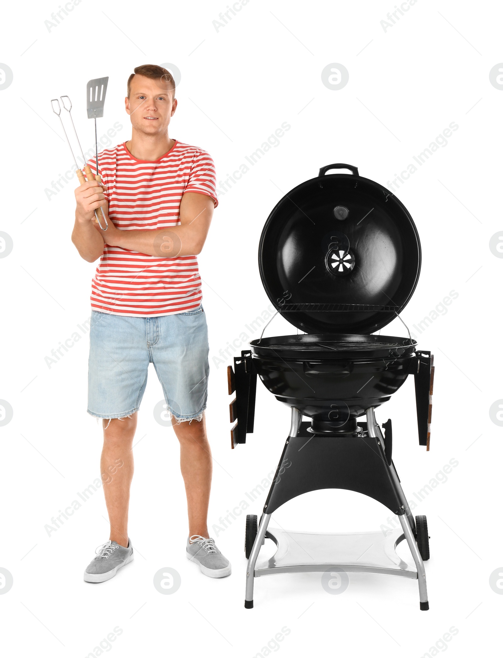 Photo of Man with barbecue grill and utensils on white background