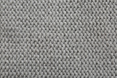 Photo of Beautiful grey knitted fabric as background, top view