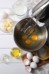 Photo of Making dough. Raw eggs in bowl of stand mixer and ingredients on white wooden table, flat lay