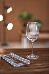 Photo of Empty wine glass on wooden table in restaurant