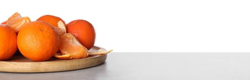 Photo of Delicious fresh tangerines on table against white background. Space for text