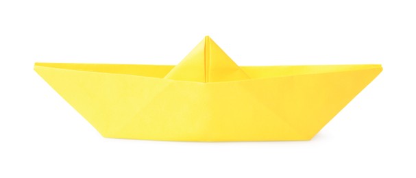 Photo of Yellow paper boat isolated on white. Origami art
