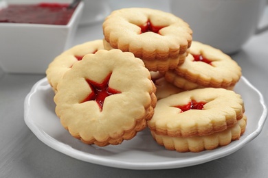 Traditional Christmas Linzer cookies with sweet jam on plate