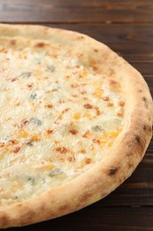 Delicious cheese pizza on wooden table, closeup