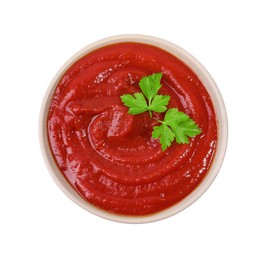 Photo of Organic ketchup and parsley in bowl isolated on white, top view. Tomato sauce