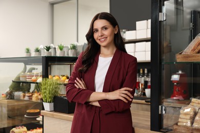 Photo of Portrait of happy business owner in her cafe