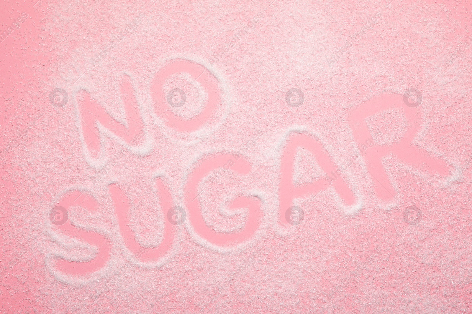 Photo of Words No Sugar on pink background, top view