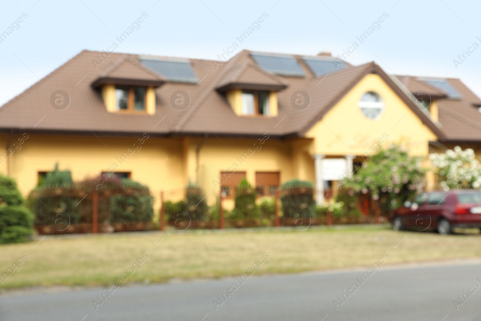 Photo of Blurred view of beautiful house with car parked nearby