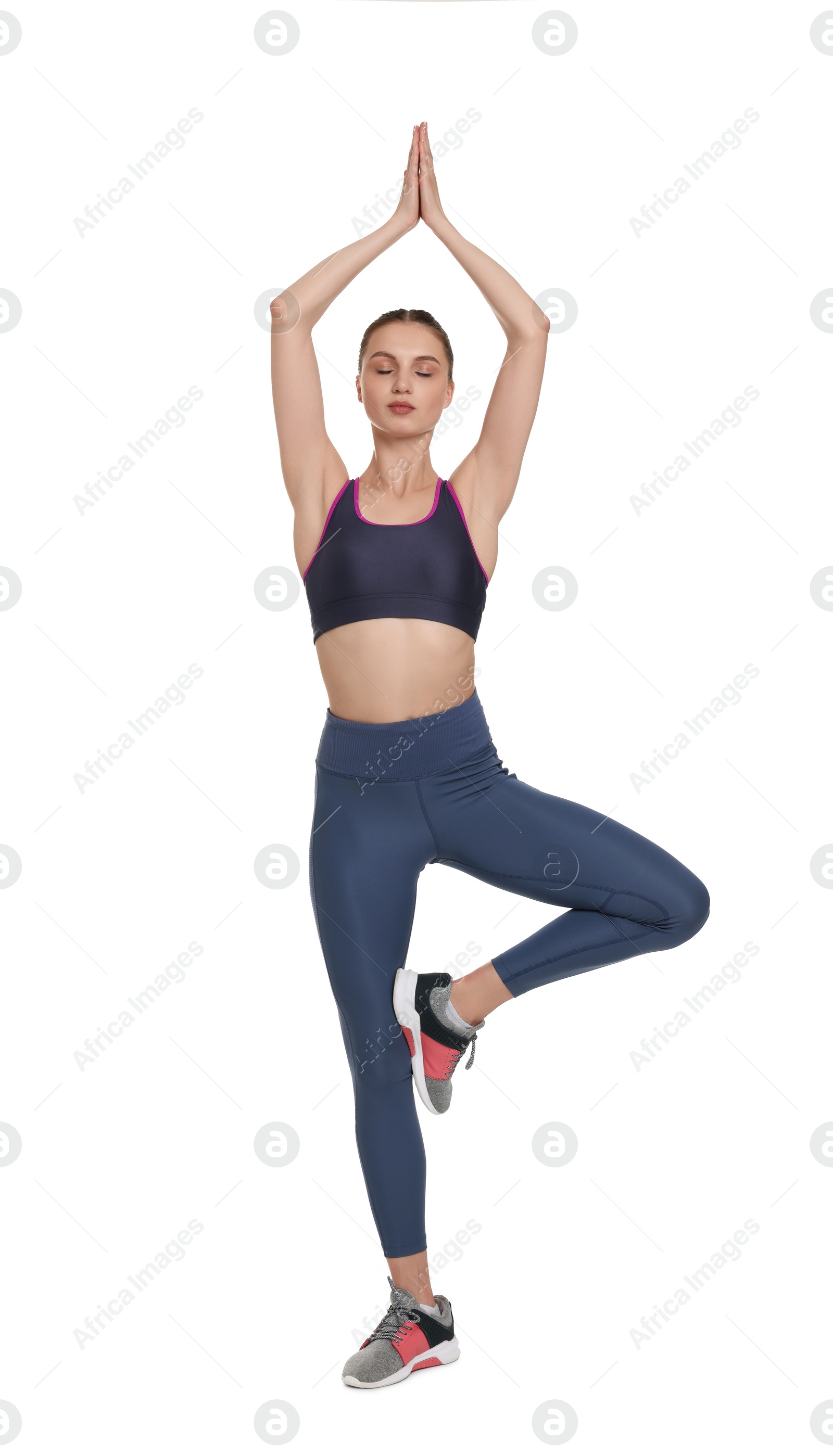 Photo of Young woman practicing yoga on white background