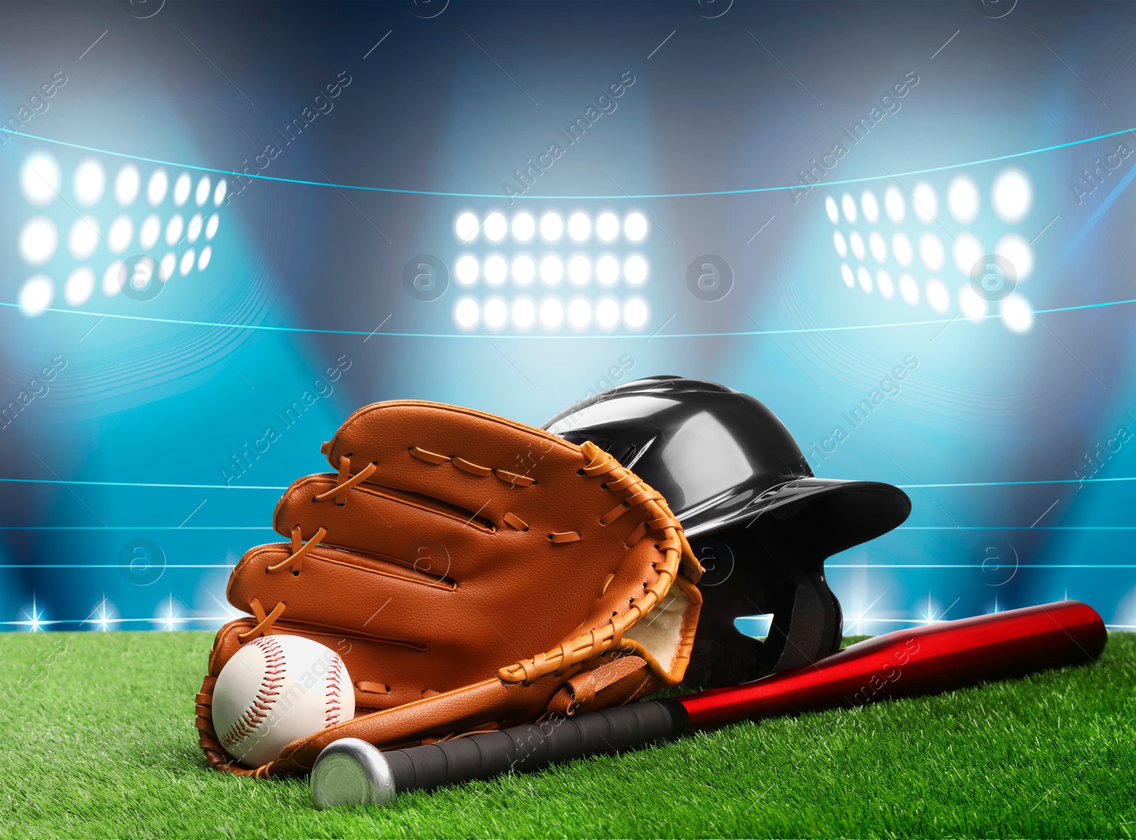 Image of Baseball bat, glove, helmet and ball on grass at stadium