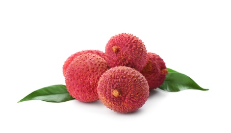 Pile of fresh ripe lychees with green leaves on white background