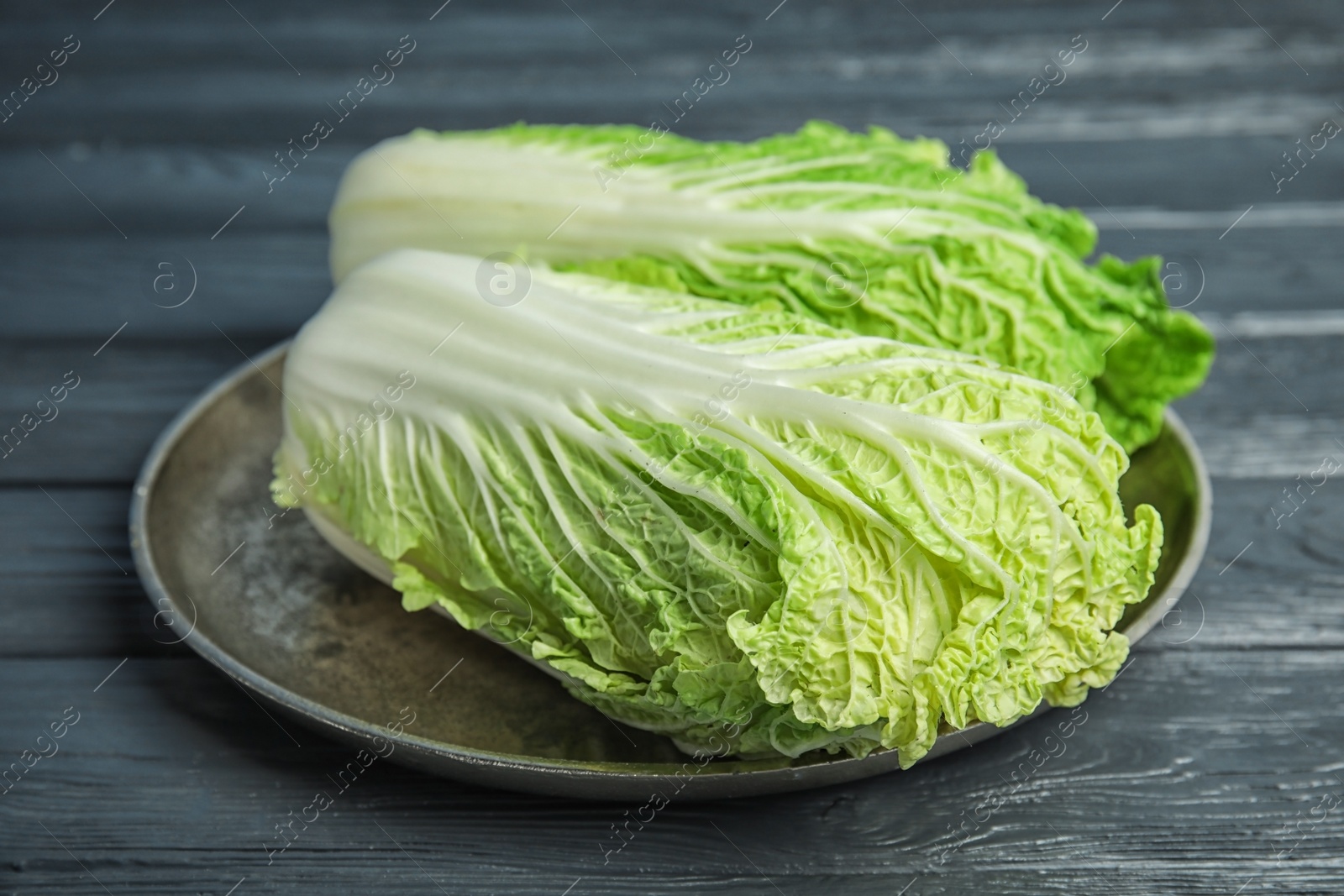 Photo of Plate with fresh ripe cabbages on table