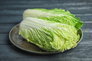 Plate with fresh ripe cabbages on table