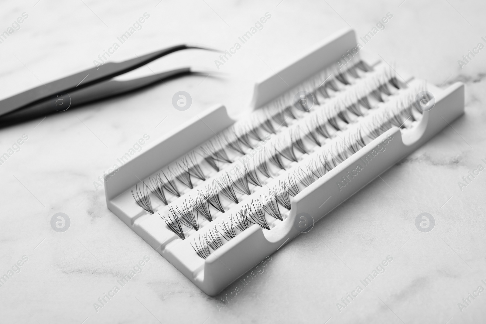 Photo of Pack with artificial eyelashes on table, closeup