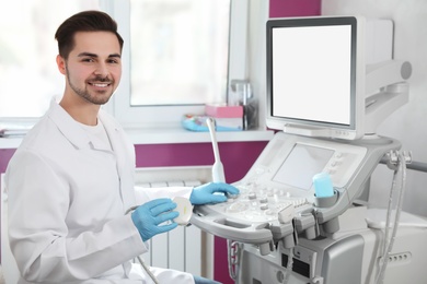 Photo of Sonographer using modern ultrasound machine in clinic