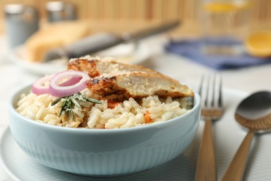 Photo of Delicious chicken risotto served in bowl on table