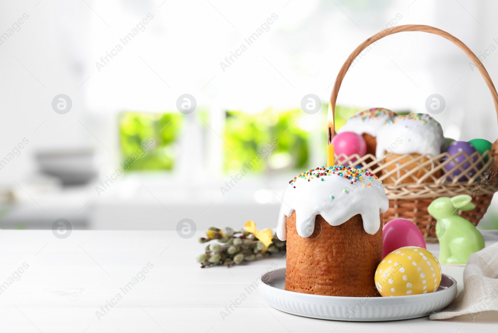 Image of Delicious Easter cakes and painted eggs on white table indoors. Space for text