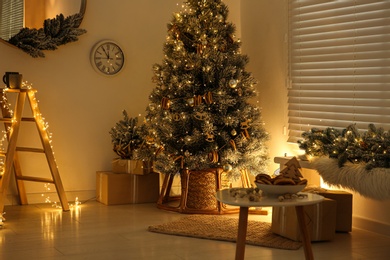 Beautiful decorated Christmas tree in festive room interior