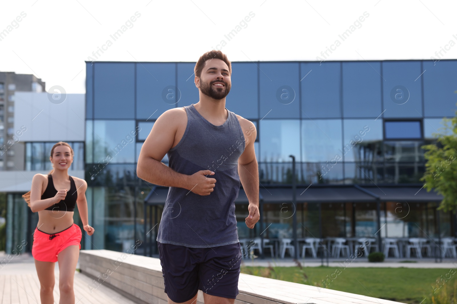 Photo of Healthy lifestyle. Happy couple running outdoors. Space for text