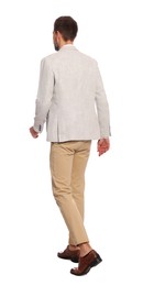 Man in stylish outfit walking on white background