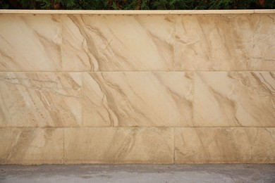 Beige marble wall of building outdoors. Exterior design