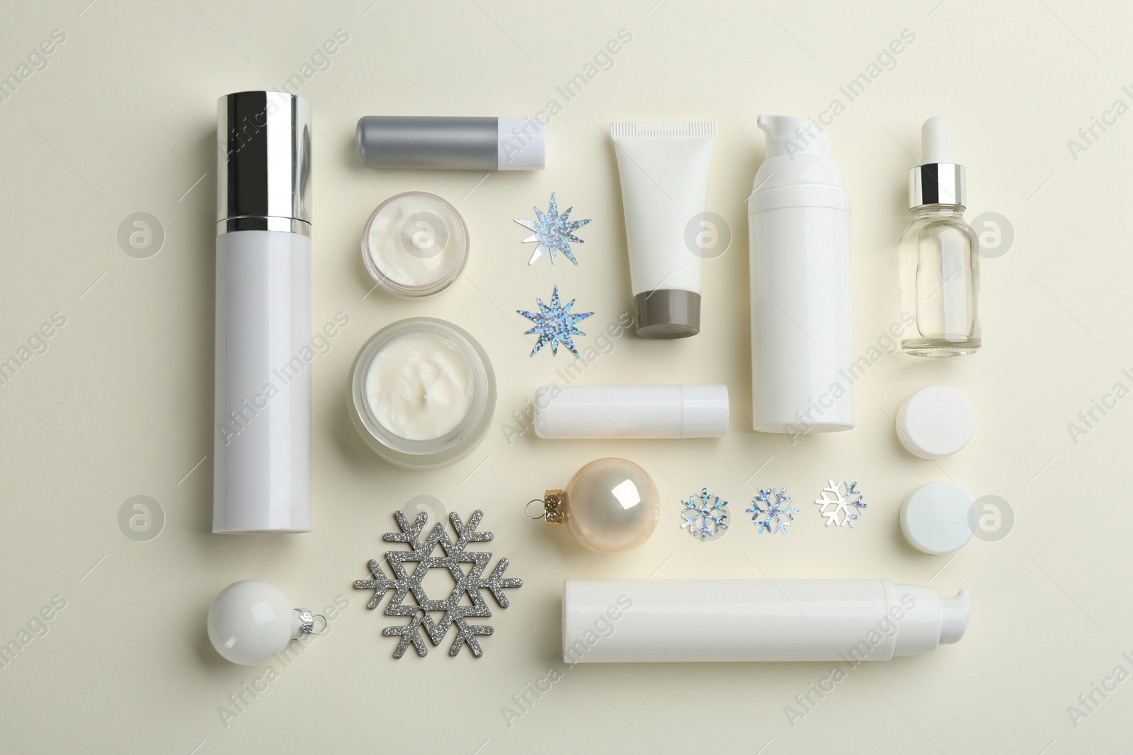 Photo of Flat lay composition with different cosmetic products on beige background. Winter care