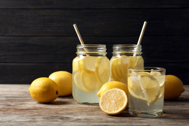 Photo of Natural lemonade in glassware on wooden table