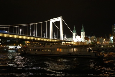 BUDAPEST, HUNGARY - APRIL 27, 2019: Beautiful night cityscape with illuminated Elisabeth Bridge across Danube river