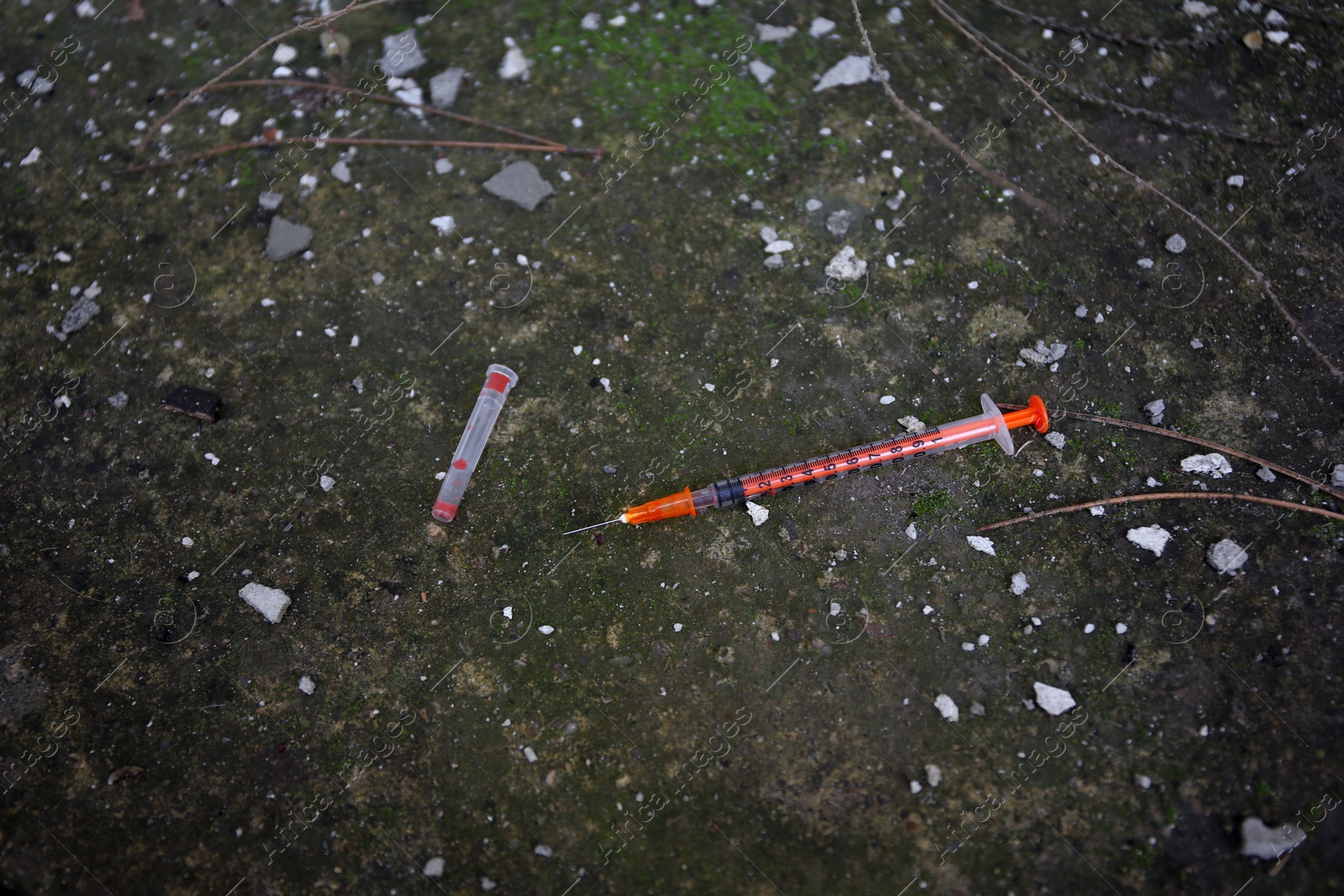 Photo of Empty disposable syringe with needle on street