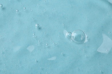 Photo of Cosmetic serum on light blue background, above view