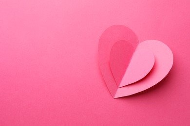 Photo of Paper hearts on pink background, top view. Space for text