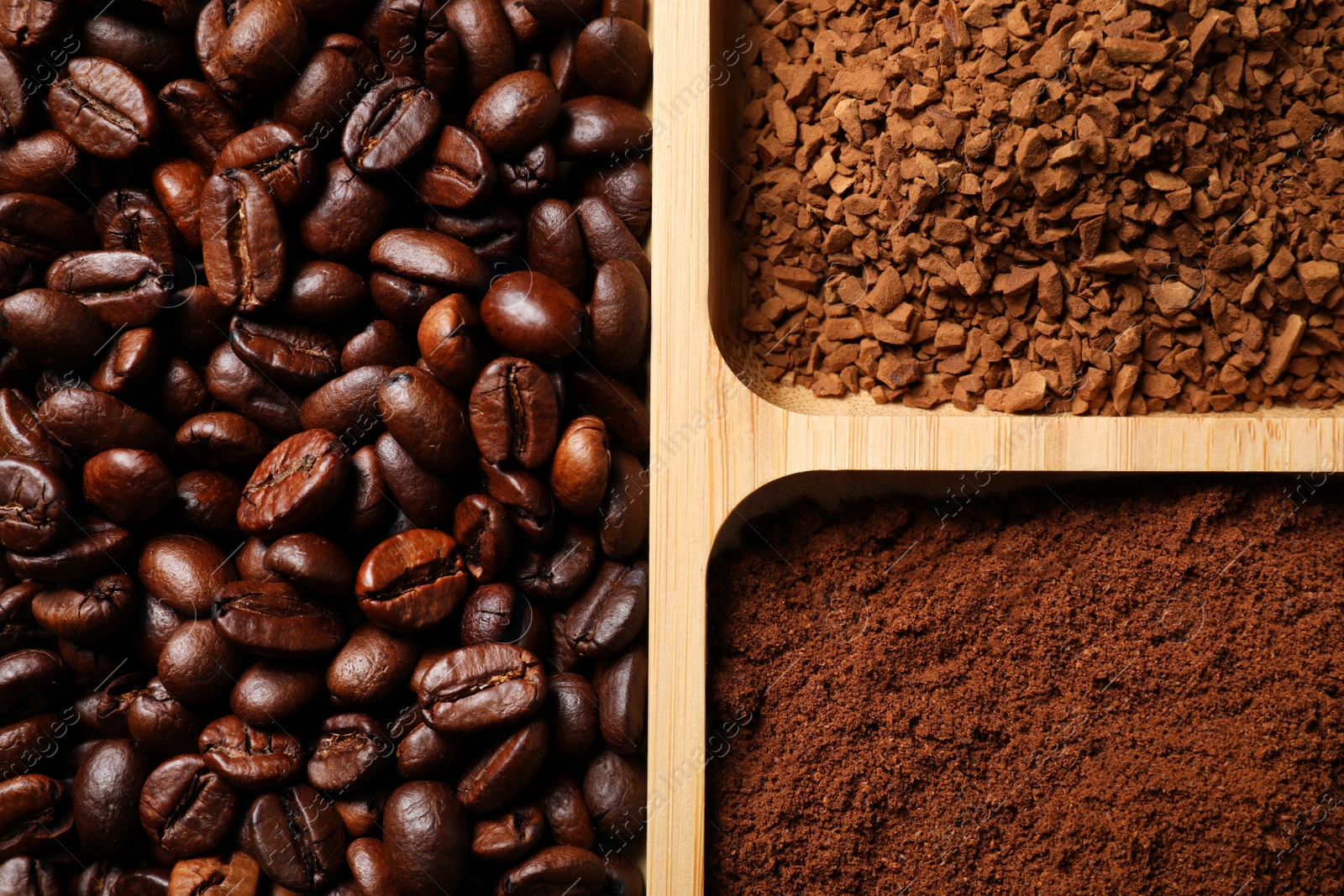 Photo of Instant, ground coffee and roasted beans in wooden container, closeup