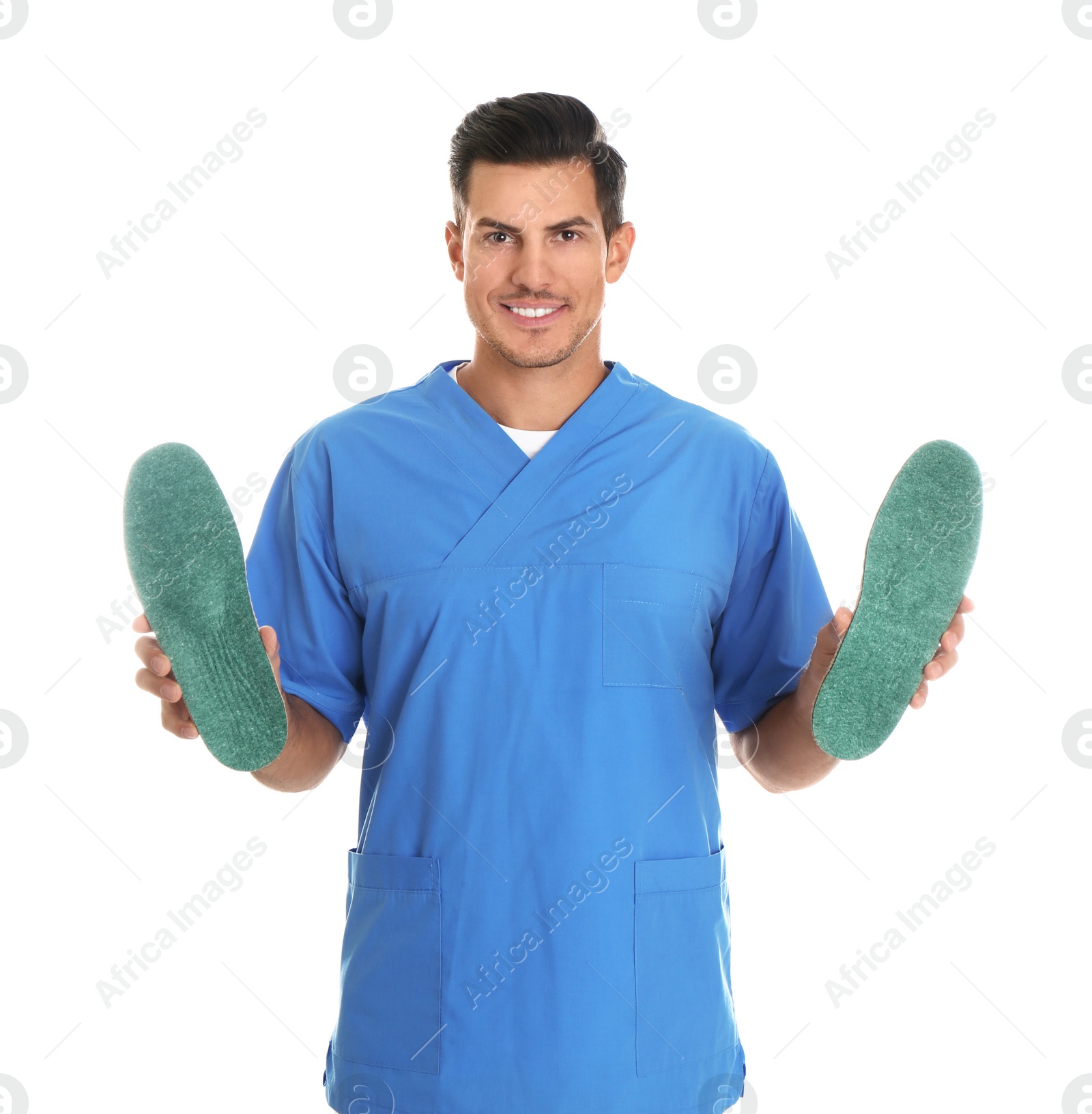 Photo of Male orthopedist showing insoles on white background