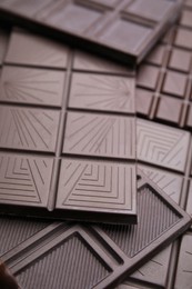 Many tasty chocolate bars as background, closeup