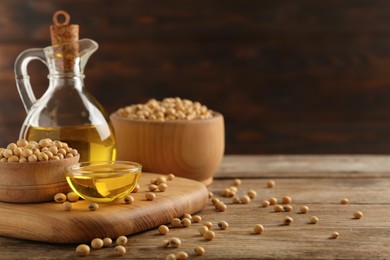 Photo of Composition with soybean oil on wooden table, space for text