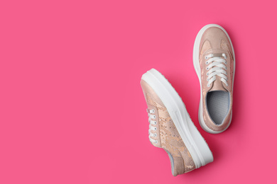 Photo of Stylish shoes on pink background, flat lay. Space for text