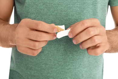 Man with sticking plaster on white background, closeup
