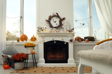 Modern room with fireplace decorated for Halloween. Festive interior