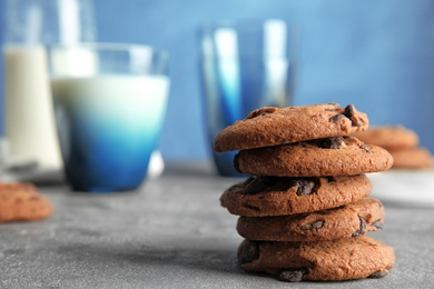 Photo of Stack of tasty chocolate chip cookies on table. Space for text