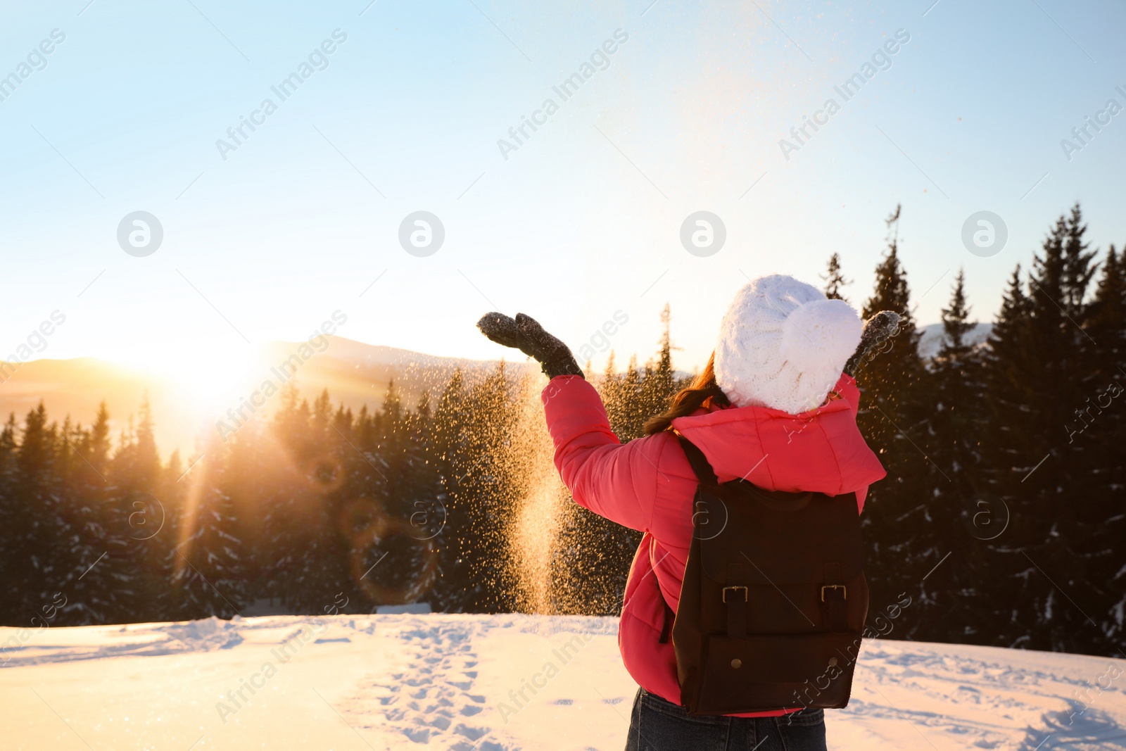 Photo of Young woman having fun outdoors on snowy winter day. Space for text