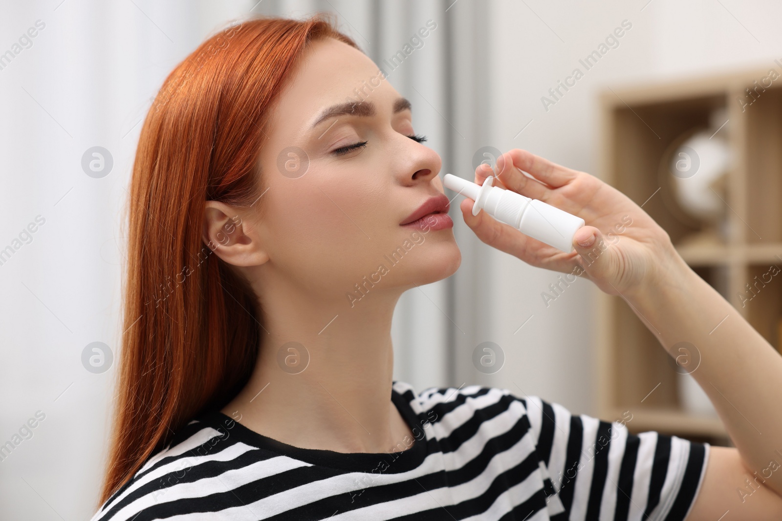 Photo of Medical drops. Woman using nasal spray at home