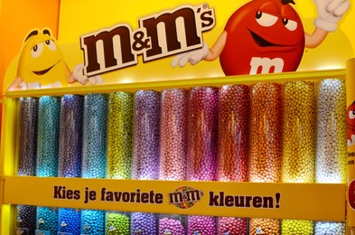 Photo of AMSTERDAM, NETHERLANDS - JULY 16, 2022: Assortment of M&M's chocolate dragee in Captain Candy shop