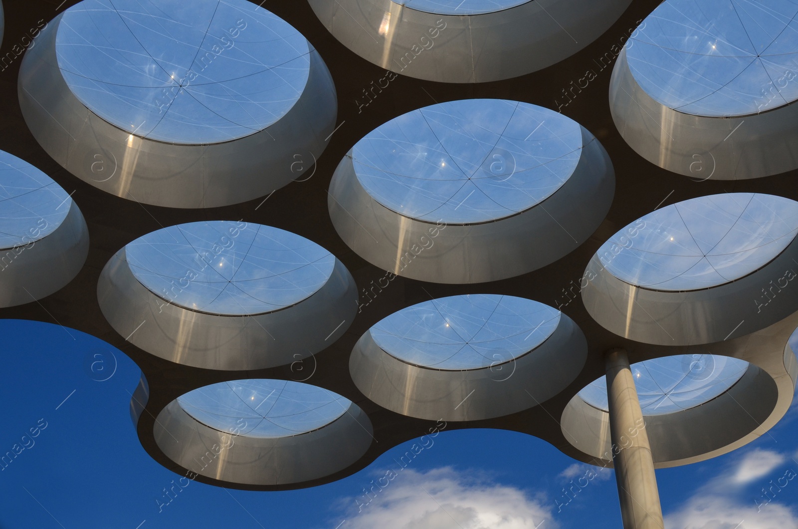 Photo of Artistic round windows near entrance in shopping mall, low angle view