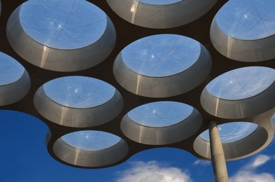 Artistic round windows near entrance in shopping mall, low angle view